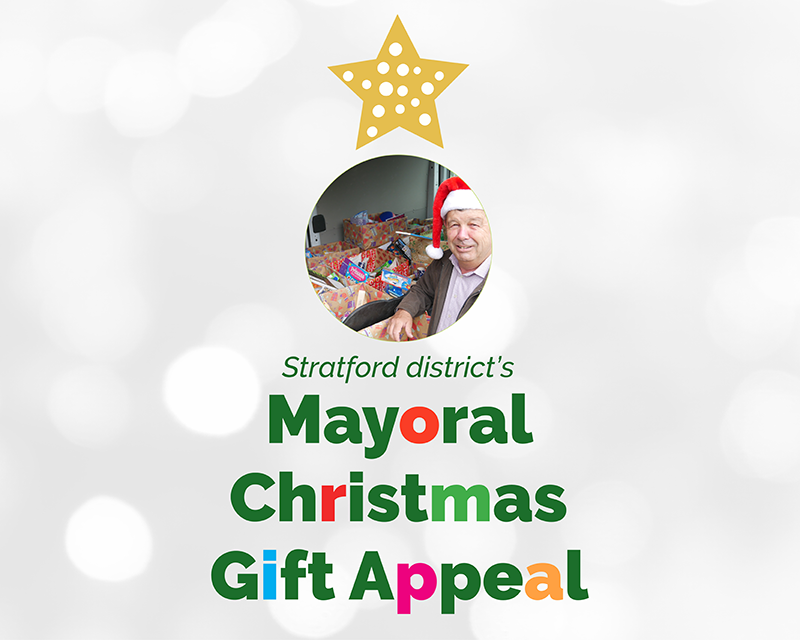 A Christmas tree made out of text: "Stratford district's Christmas Gift Appeal". There's a photo of Mayor Volzke wearing a Christmas hat and a star at the top of the tree