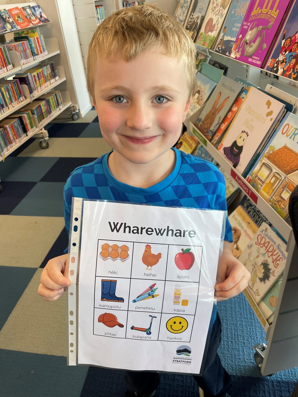 Picture of boy holding the wharewhare resource